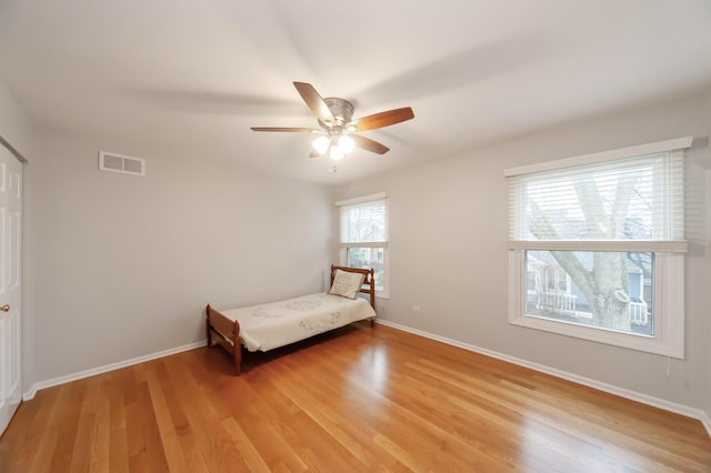 unfurnished bedroom with ceiling fan, light wood finished floors, visible vents, and baseboards