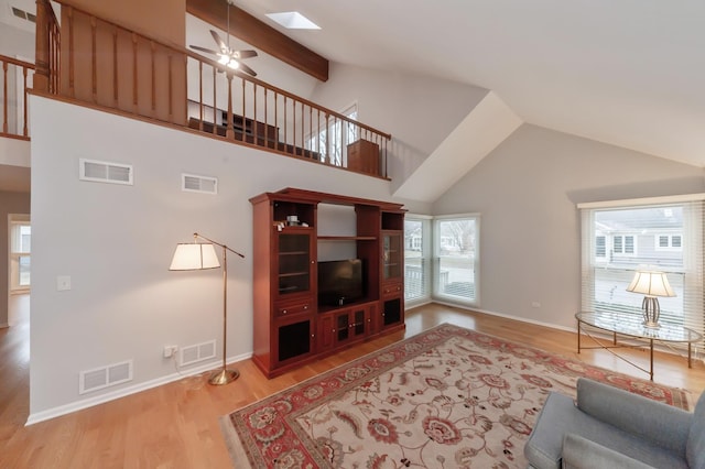 living area with light wood-style flooring and visible vents