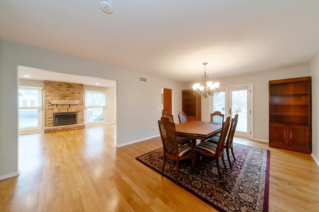 dining space with light wood-style floors, plenty of natural light, and baseboards