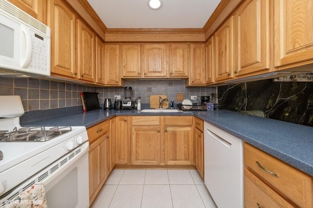 kitchen with white appliances, light tile patterned flooring, a sink, and backsplash