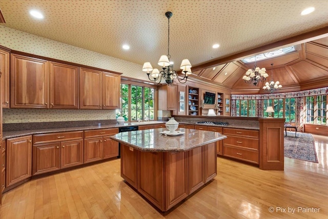 kitchen featuring an inviting chandelier, brown cabinets, and a center island