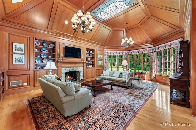 living area with visible vents, lofted ceiling, wooden ceiling, built in shelves, and a chandelier