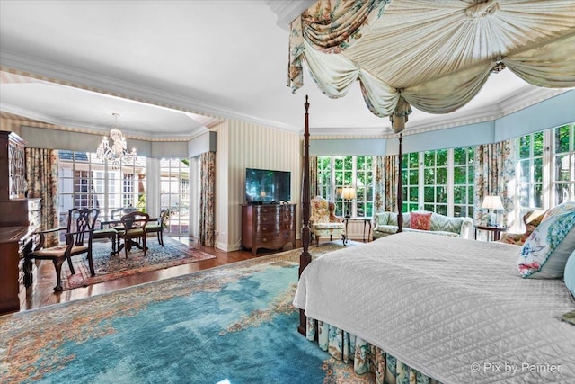 bedroom with a chandelier, multiple windows, wood finished floors, and crown molding