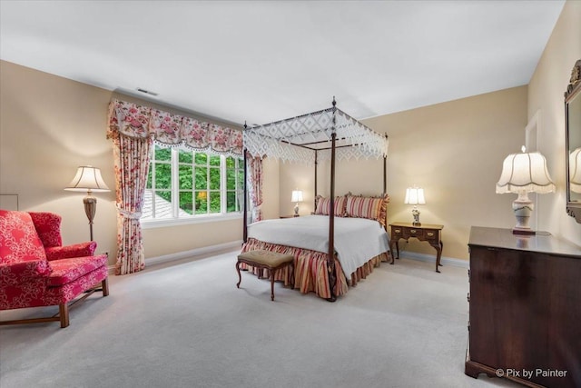 carpeted bedroom with visible vents and baseboards