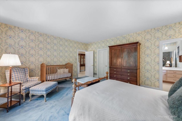 bedroom featuring carpet floors, wallpapered walls, and connected bathroom