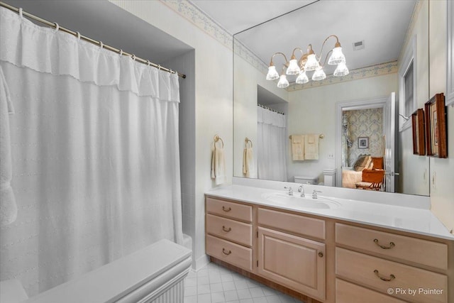 ensuite bathroom featuring a shower with shower curtain, toilet, tile patterned floors, vanity, and a chandelier