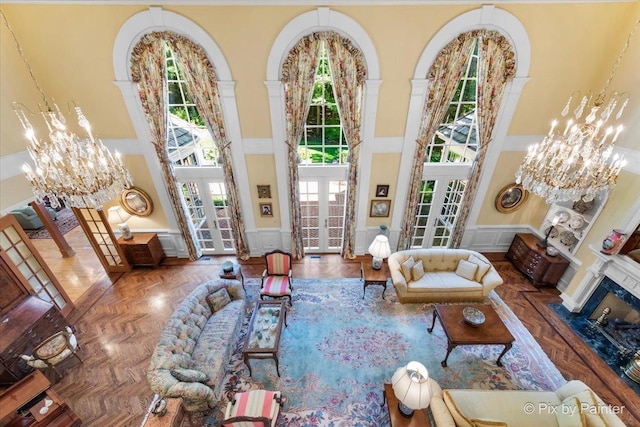 living area with french doors, a decorative wall, and a towering ceiling