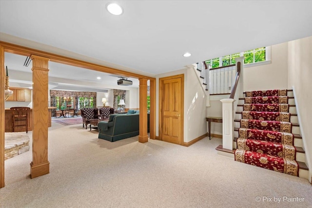 carpeted living room featuring plenty of natural light, stairway, and recessed lighting