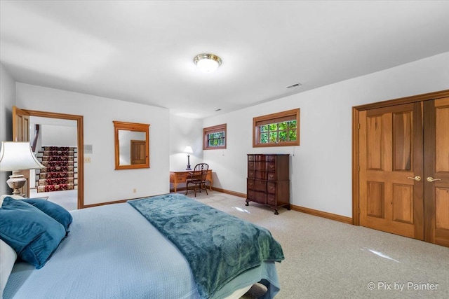 bedroom with carpet flooring, visible vents, and baseboards