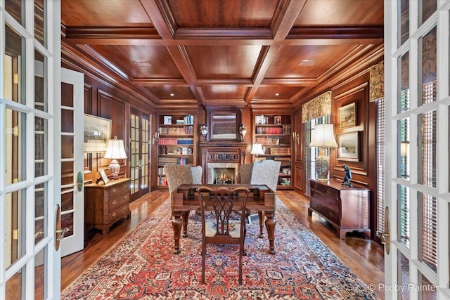 office area featuring wooden walls, built in features, coffered ceiling, wooden ceiling, and french doors