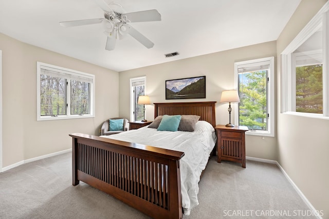 bedroom with carpet, visible vents, baseboards, and ceiling fan