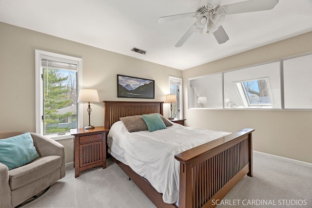 bedroom featuring light carpet, baseboards, visible vents, and a ceiling fan