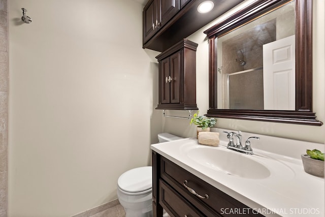 full bathroom featuring baseboards, vanity, a shower stall, and toilet