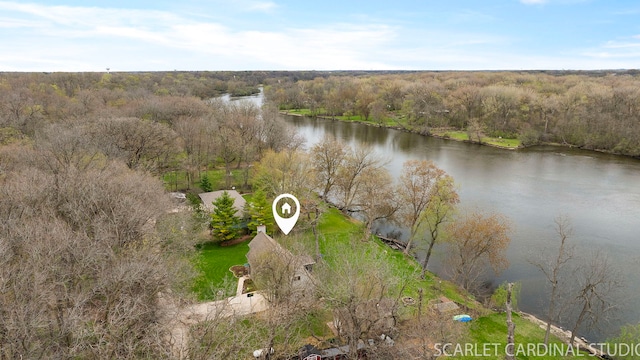 drone / aerial view with a forest view and a water view