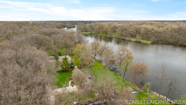 aerial view with a wooded view and a water view