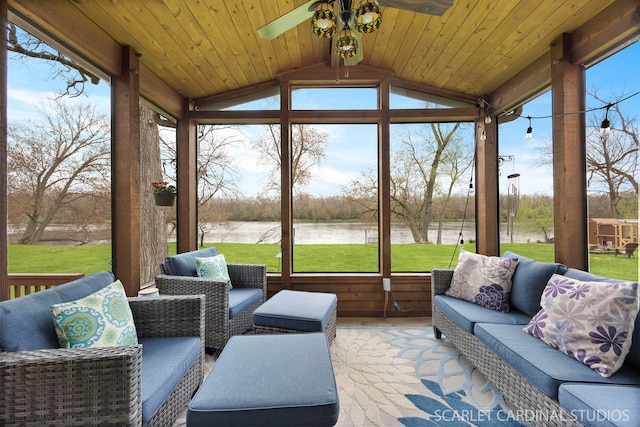 sunroom / solarium featuring a water view, ceiling fan, and an outdoor living space