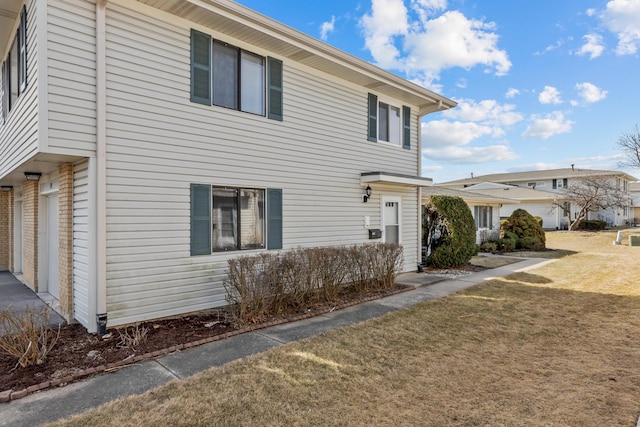 view of home's exterior with a yard