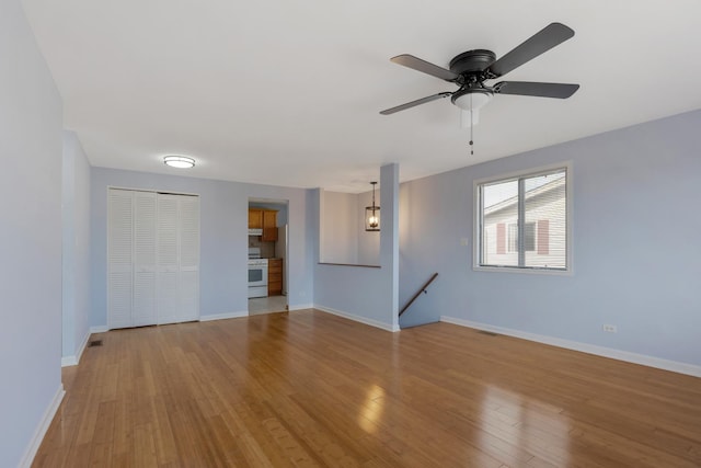 unfurnished room featuring hardwood / wood-style flooring and baseboards