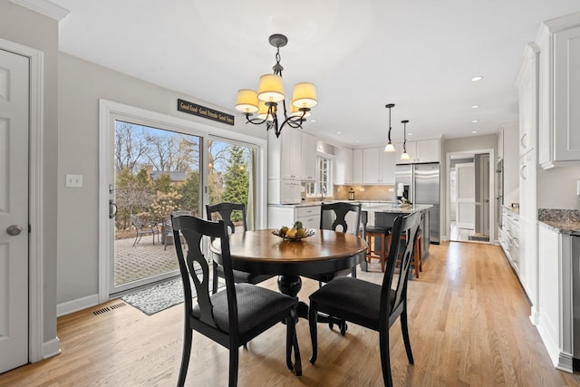 dining area with light wood finished floors, baseboards, visible vents, a chandelier, and recessed lighting