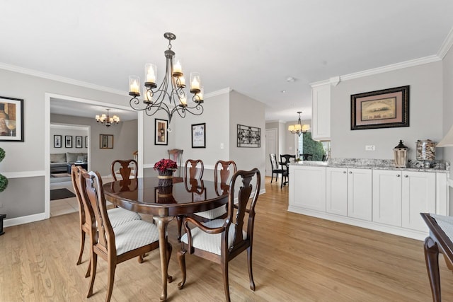 dining room with an inviting chandelier, crown molding, baseboards, and light wood-style floors