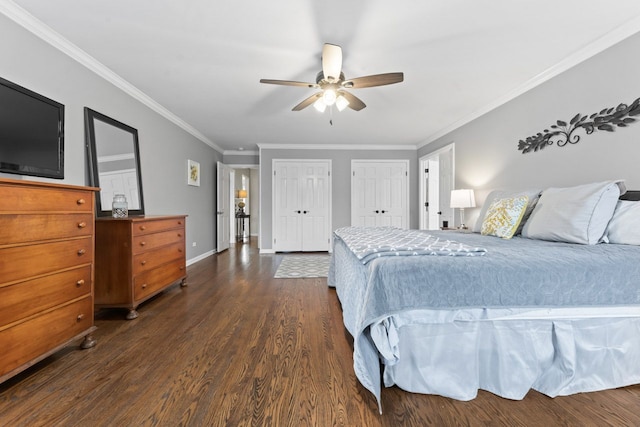 bedroom with ceiling fan, baseboards, multiple closets, ornamental molding, and dark wood-style floors