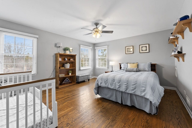 bedroom with ceiling fan, wood finished floors, and baseboards