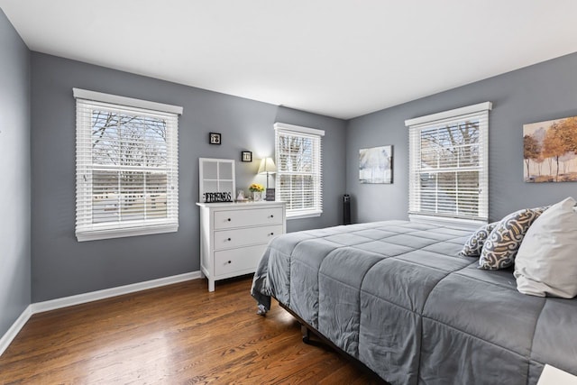 bedroom with wood finished floors and baseboards