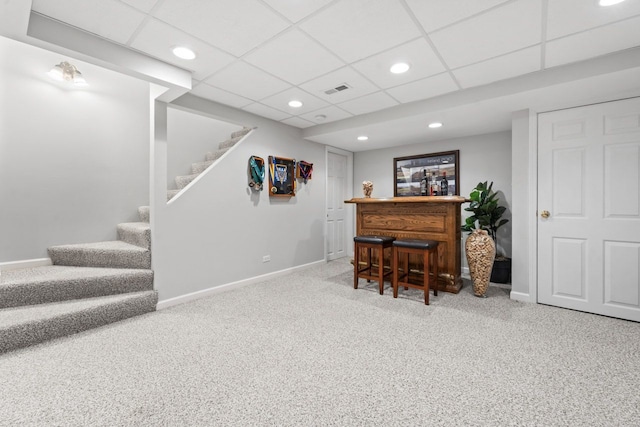 bar featuring a bar, carpet floors, baseboards, and stairway