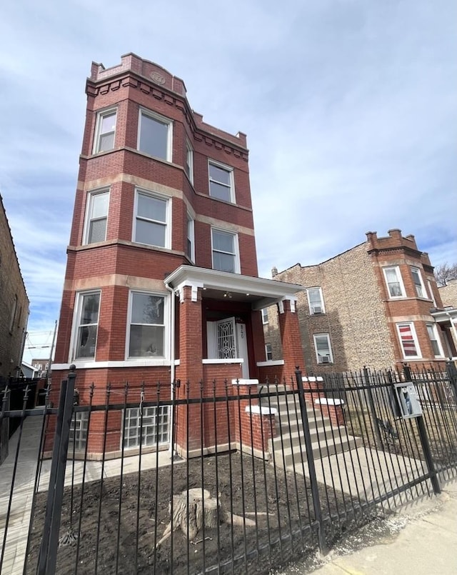 view of front facade featuring a fenced front yard and brick siding