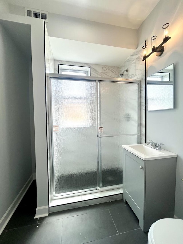 full bath featuring tile patterned flooring, toilet, vanity, visible vents, and a stall shower