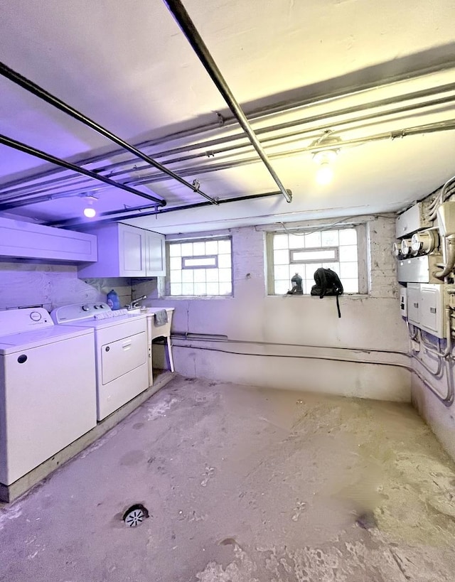 basement featuring washer and dryer and a sink