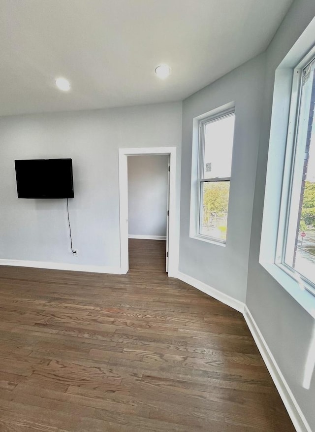 unfurnished living room featuring baseboards, dark wood-style flooring, and recessed lighting