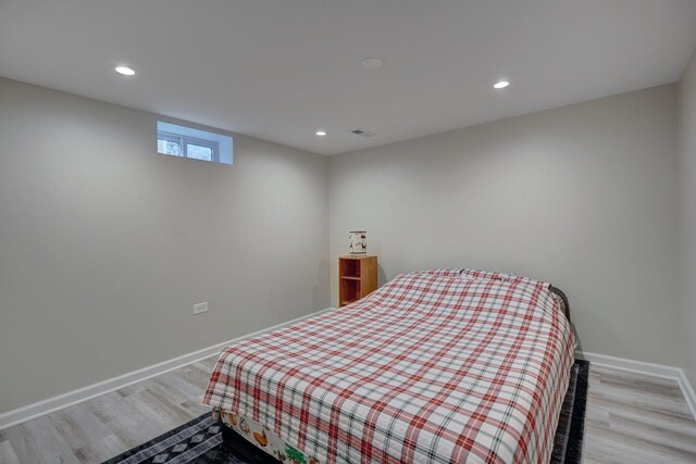 bedroom with recessed lighting, visible vents, light wood-type flooring, and baseboards