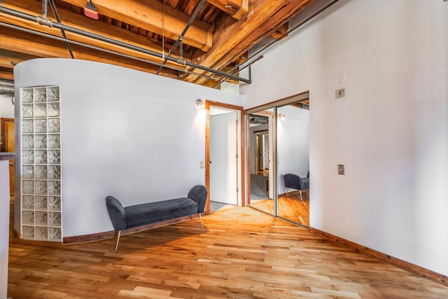 interior space featuring baseboards and wood finished floors