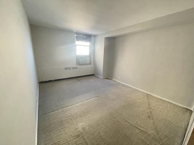 unfurnished room with baseboards