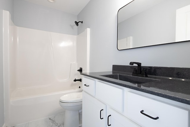 bathroom with marble finish floor, tub / shower combination, vanity, and toilet