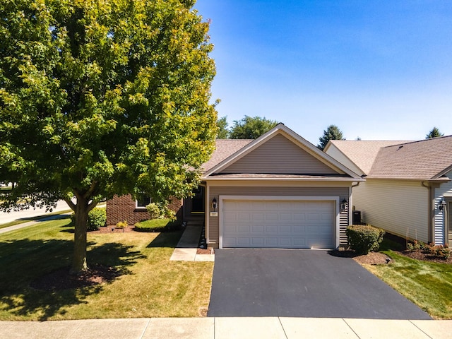 view of front of property featuring a garage, a front lawn, central AC unit, and aphalt driveway