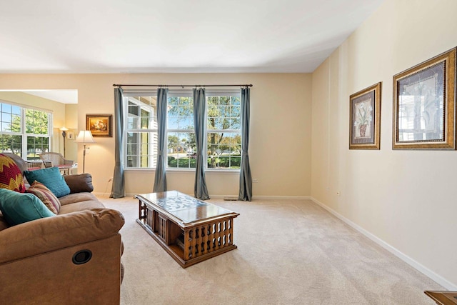 carpeted living room with baseboards