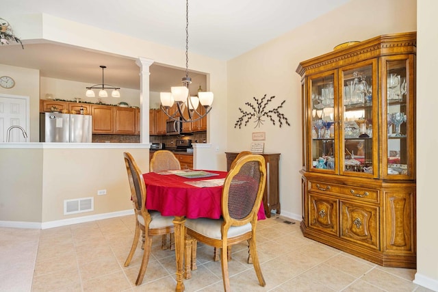 dining room with a chandelier, visible vents, baseboards, and light tile patterned floors