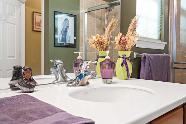 bathroom featuring a tile shower and vanity