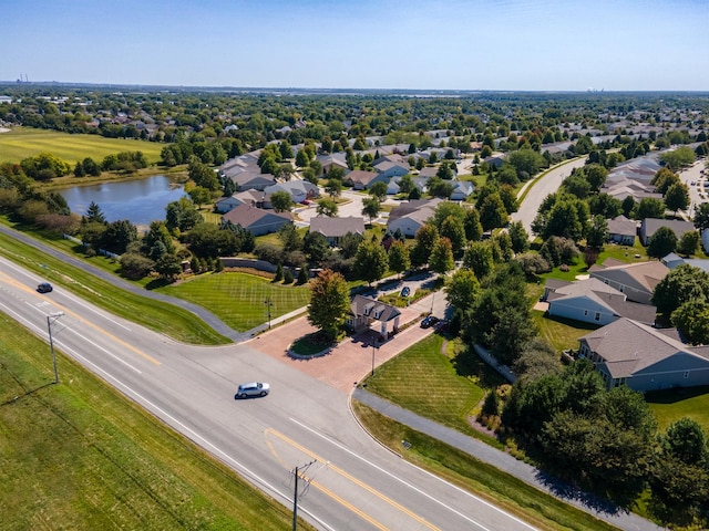 drone / aerial view with a water view and a residential view