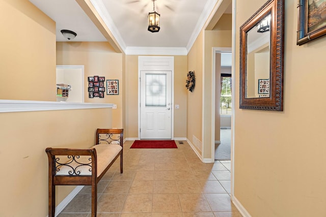 foyer entrance featuring ornamental molding, light tile patterned flooring, and baseboards