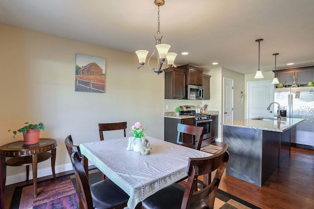 dining space with dark wood-style floors, recessed lighting, a notable chandelier, and baseboards