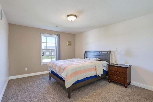 bedroom featuring baseboards and light colored carpet