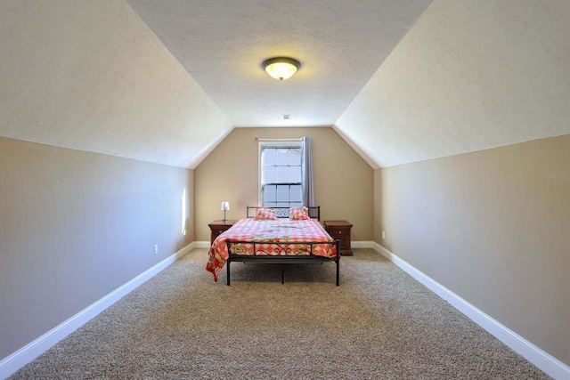 bedroom featuring lofted ceiling, baseboards, a textured ceiling, and carpet flooring