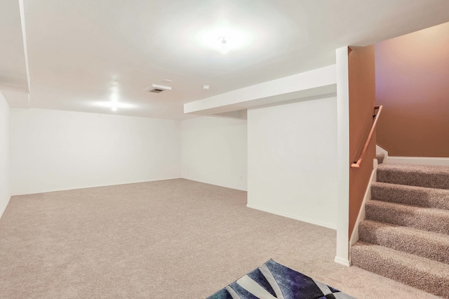 finished basement featuring stairs, carpet floors, and visible vents