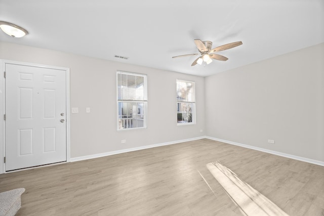 interior space with light wood-style flooring, baseboards, and ceiling fan