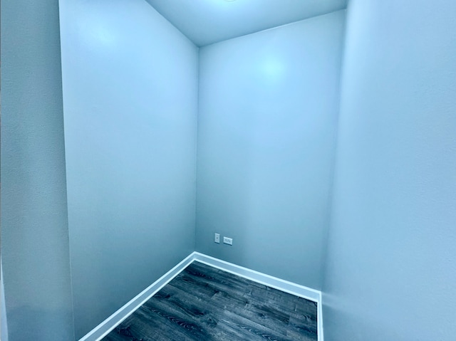 empty room featuring dark wood finished floors and baseboards