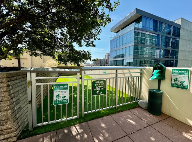 exterior space featuring a lawn and a city view