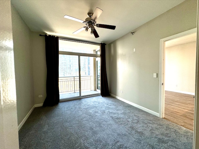 carpeted spare room with baseboards and a ceiling fan